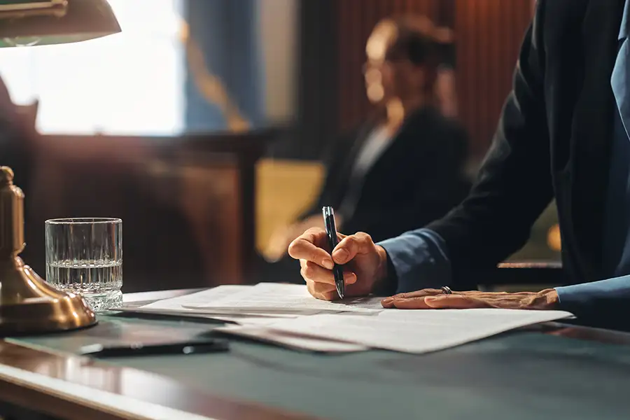 Legislator signing documents at a desk, symbolizing how legislative poison pills quietly alter and weaken good bills before passage.